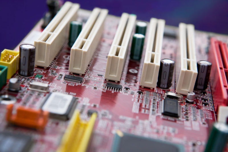 A detail image of a mother board with PCI slots. NOTE: Shallow depth of field is used to create an effective background image.