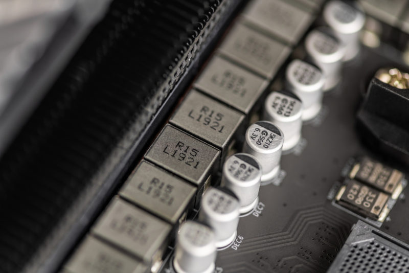 Computer components. Close up VRM zone on modern motherboard, capacitors. Close-up of the power phase of a personal computer. Socket am4