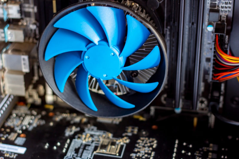 Blue cooler fan with motherboard inside a computer