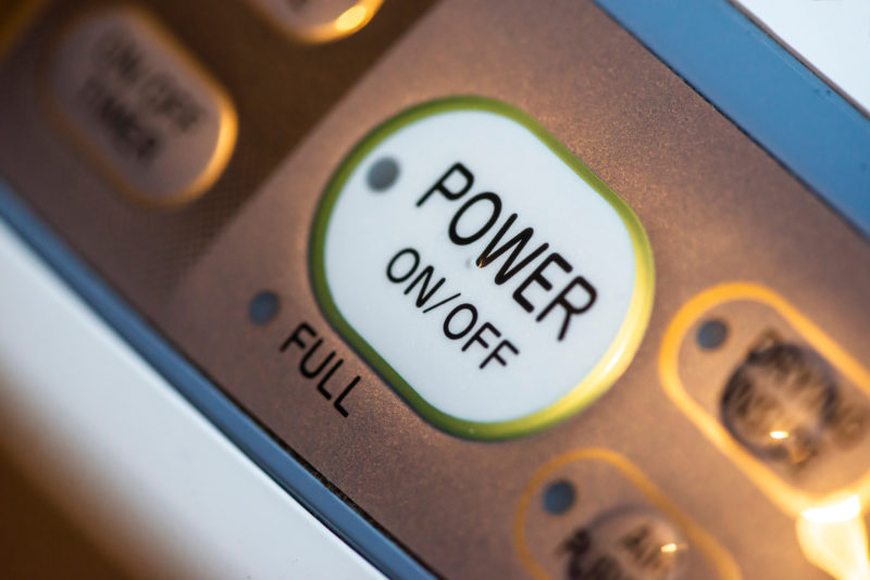 Power on button on electrical device. Close up button. Switch on/off conception.