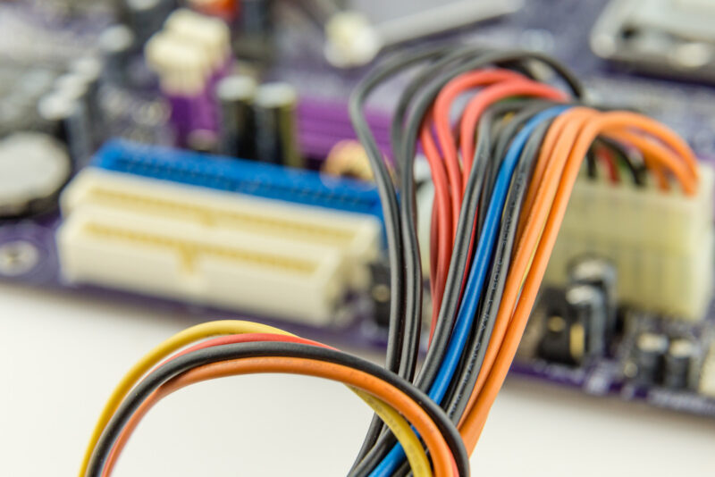 Cables connected to a computer motherboard, macro close-up